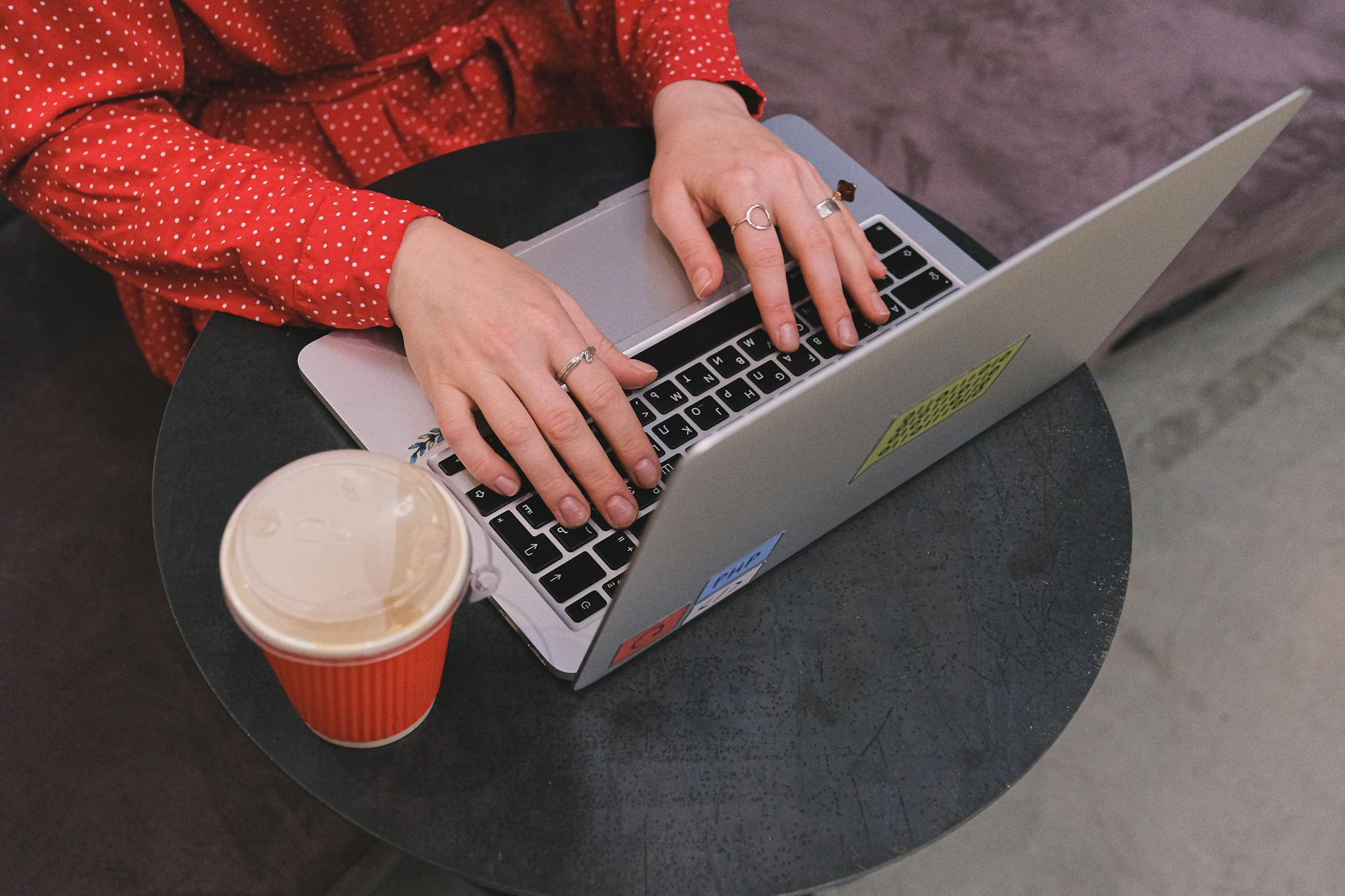 A Close-Up Shot of a Woman Typing on a Laptop